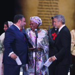 Marguerite Barankitse accepts the inaugural Aurora Prize for Awakening Humanity from George Clooney