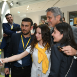 George Clooney takes a photo with students during a visit to UWC Dilijan