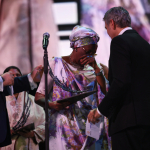 Marguerite Barankitse accepts the inaugural Aurora Prize for Awakening Humanity from George Clooney